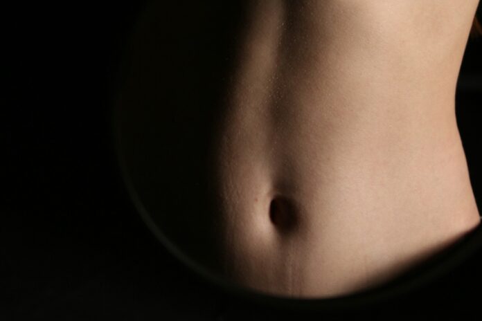 Photo by Mariia Horobets A close-up of a person's abdomen.